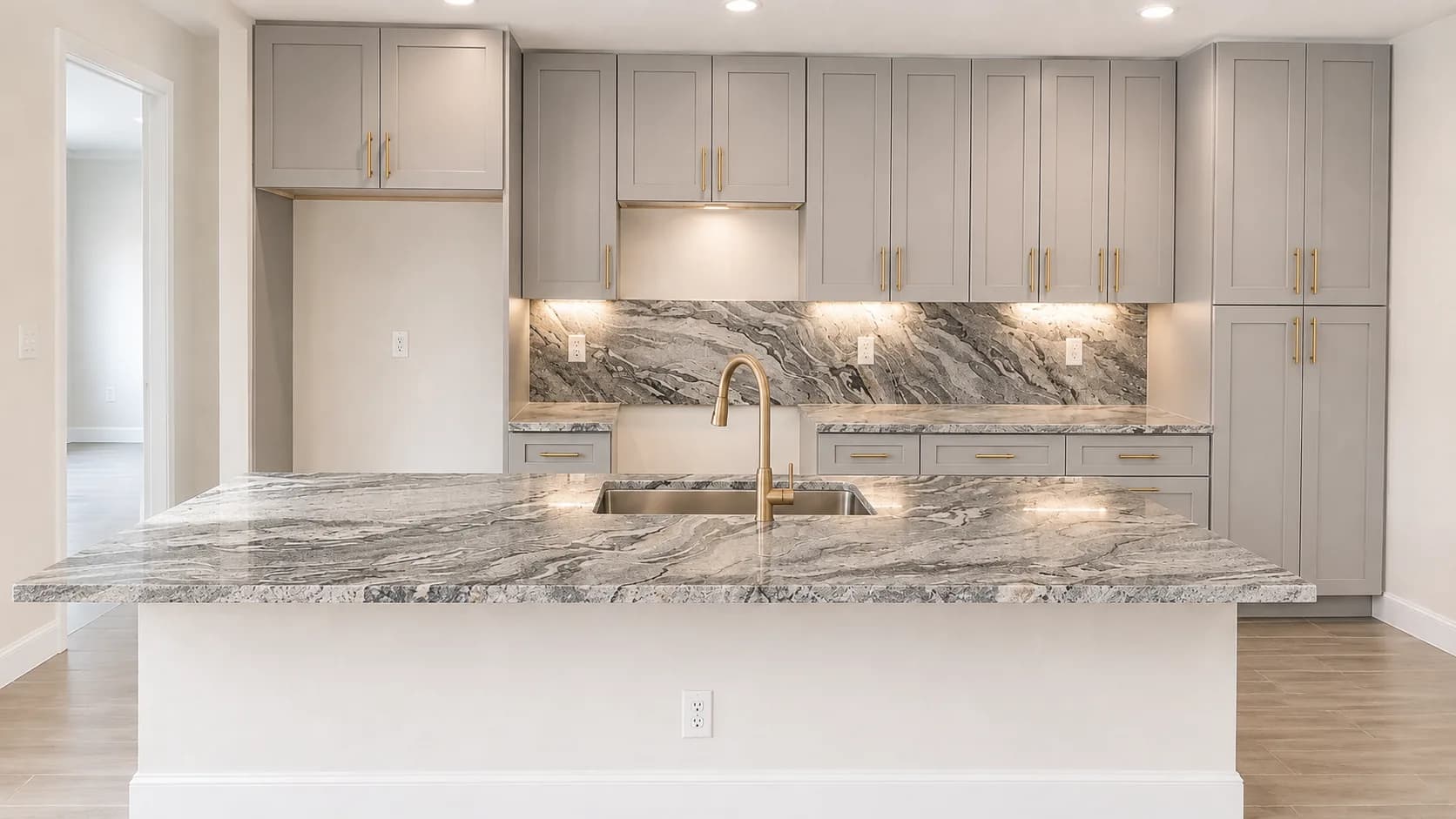 Kitchen island with a dramatic natural stone waterfall edge and matching backsplash